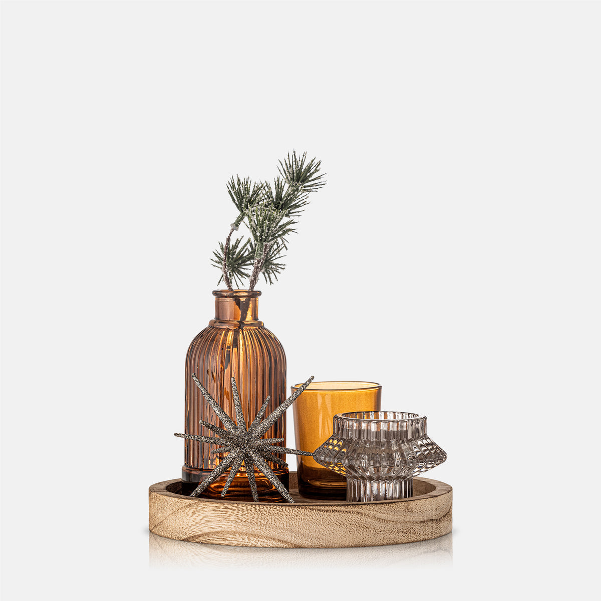 Decorative setting with a vase, candle, and star-shaped object on a white background