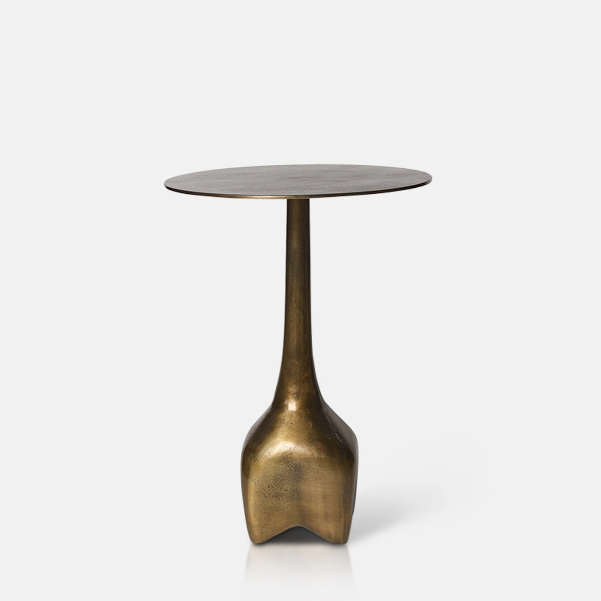 Cutout image on a white background of a gold, round metal side table with a narrow base.
