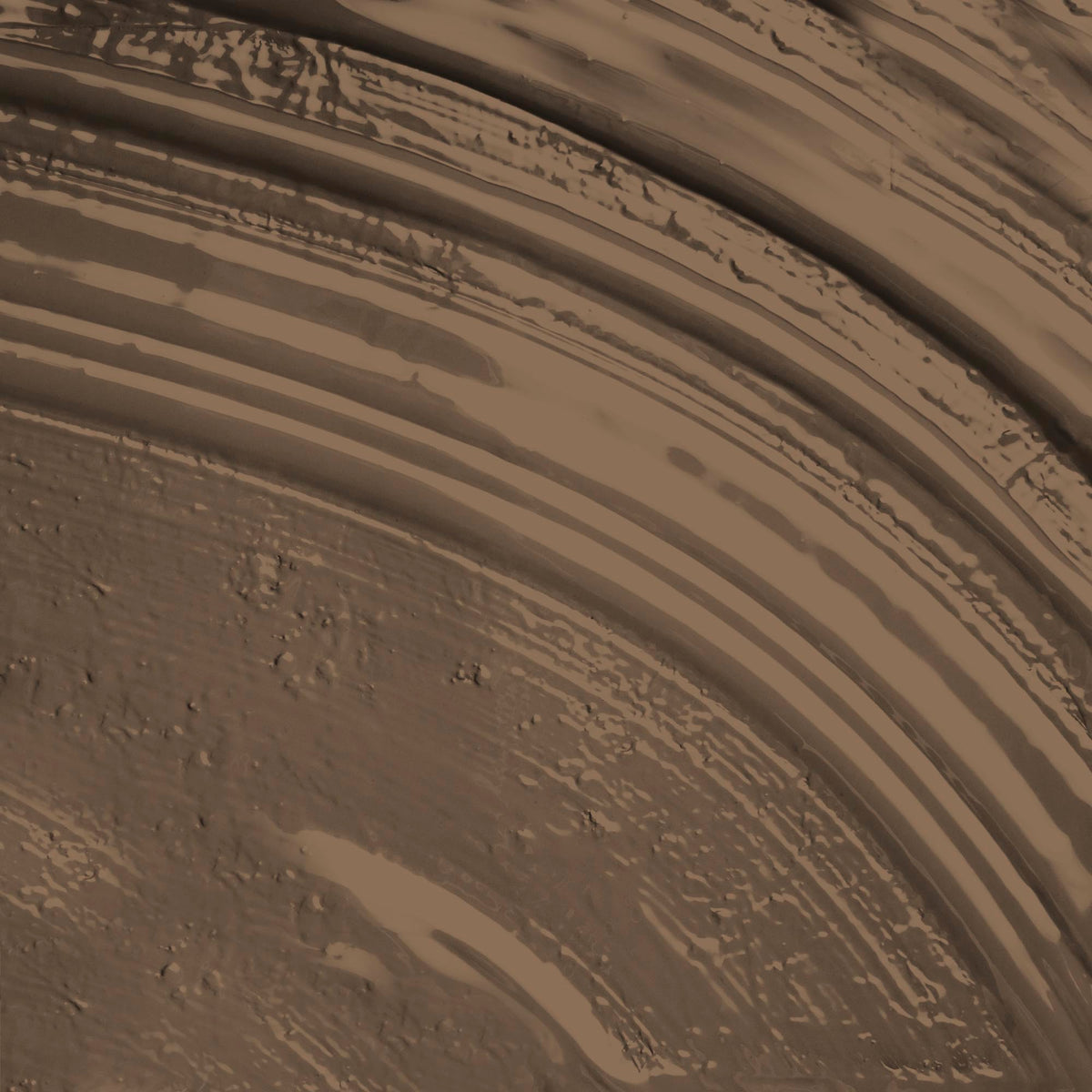 A paint stroke of a warm brown paint colour with golden undertones.