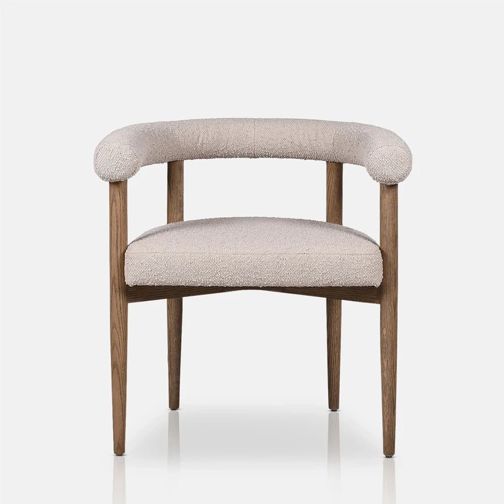 Harrington Boucle Dining Chair features a curved cream upholstered back, open centre and padded seat above straight wooden legs, shown in a front view.