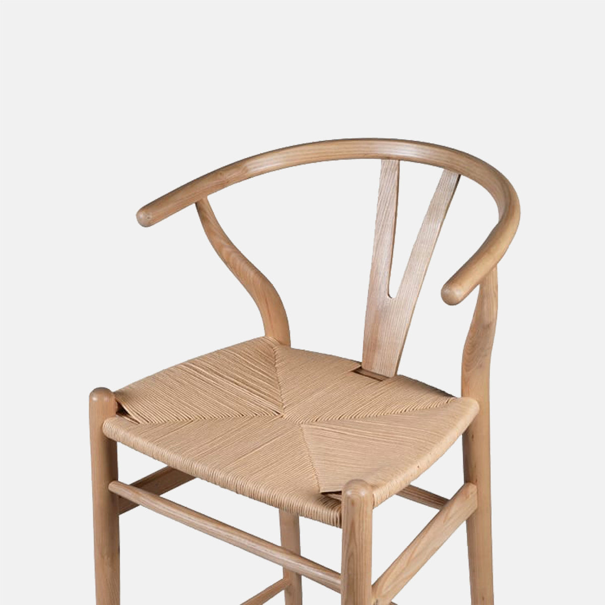 The Hurst Wishbone Bar Stool, a classic design in a light wood with a woven seat.