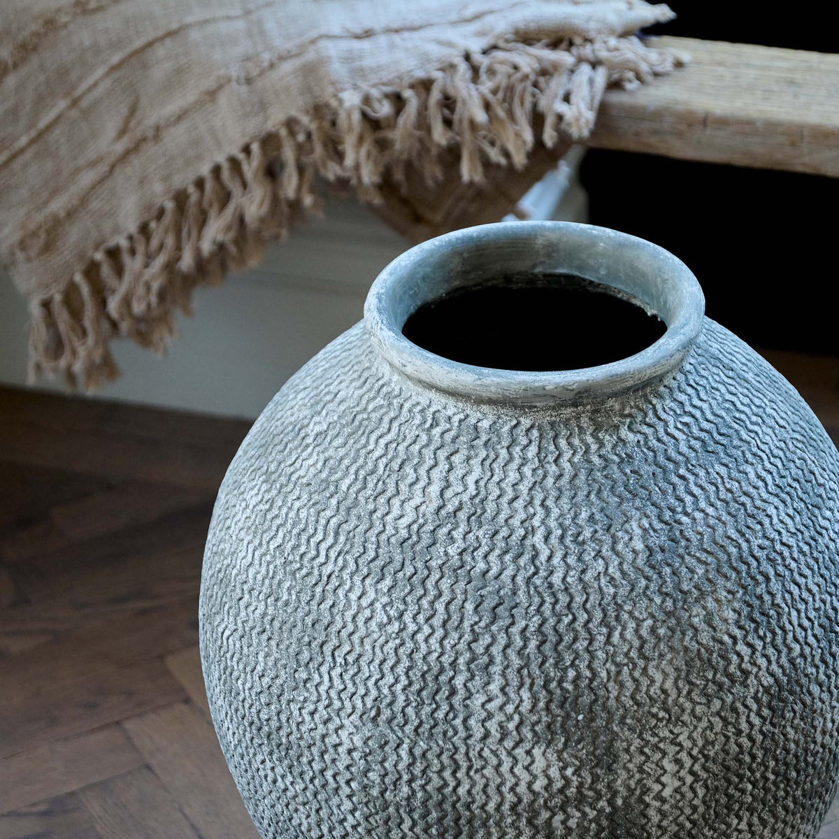 A closeup of the horizontal zigzag lined pattern on the Immi Terracotta Vase.