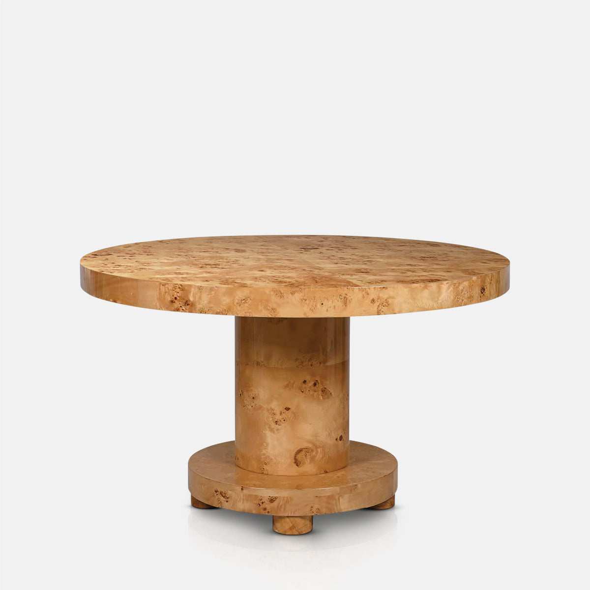 Abigail Ahern Isolde Burl Wood Dining Table in natural brown solid burl wood with a round 130cm tabletop and distinctive swirling grain, creating a statement centrepiece for the dining room.