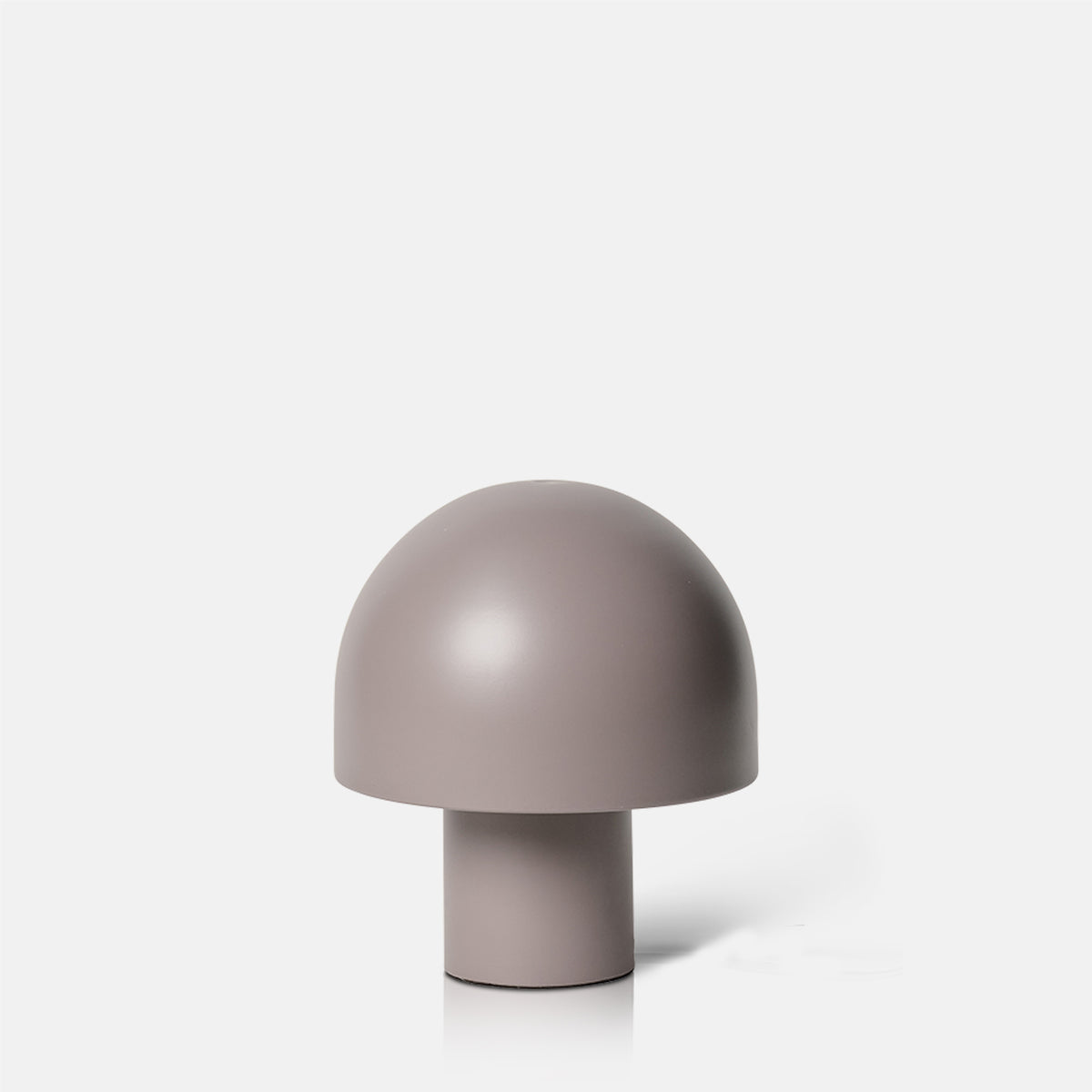 A cutout of a small portable grey table lamp  in a mushroom shape with a smooth metal finish.