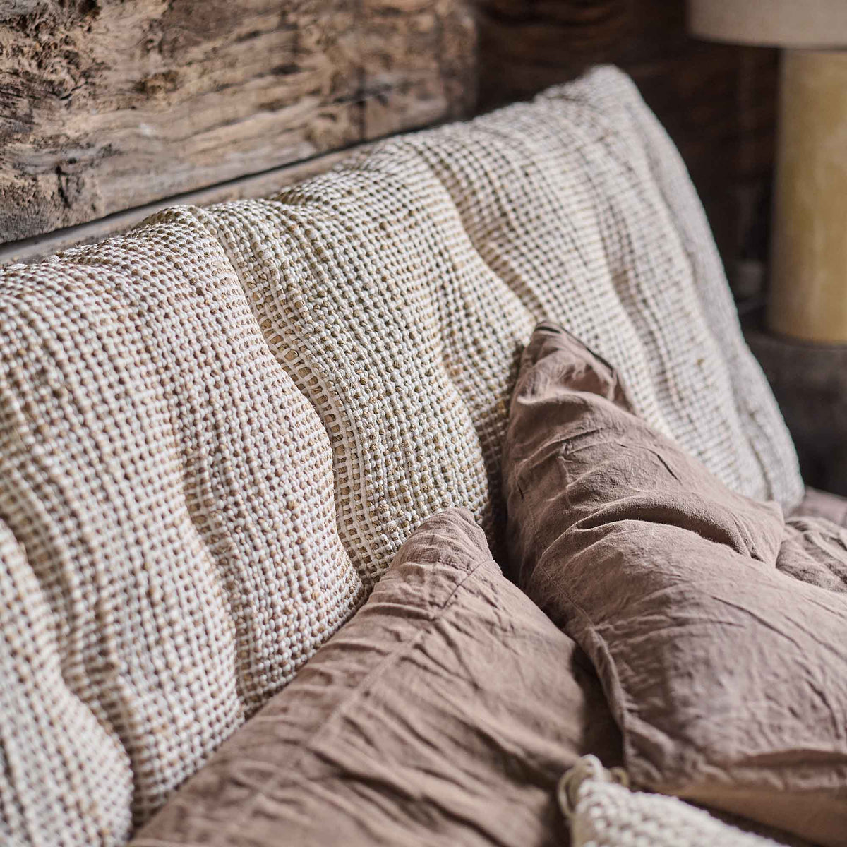 A closeup of the natural coloured woven jute and cotton textural finish on the Konta Headboard Cushion.
