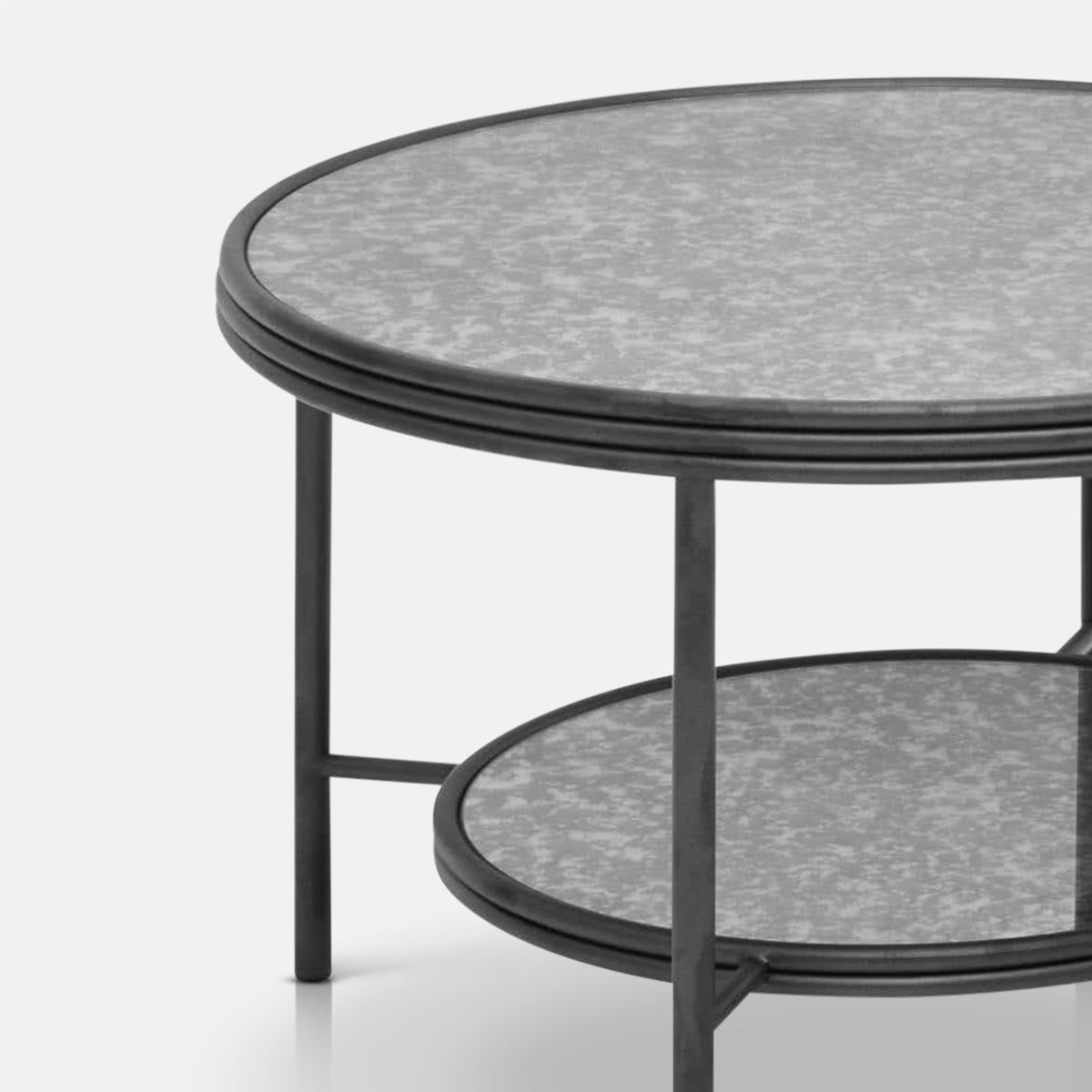 Close-up of the Abigail Ahern Leiden Coffee Table highlighting the softly aged antique mirrored glass tabletop and simple metal frame.