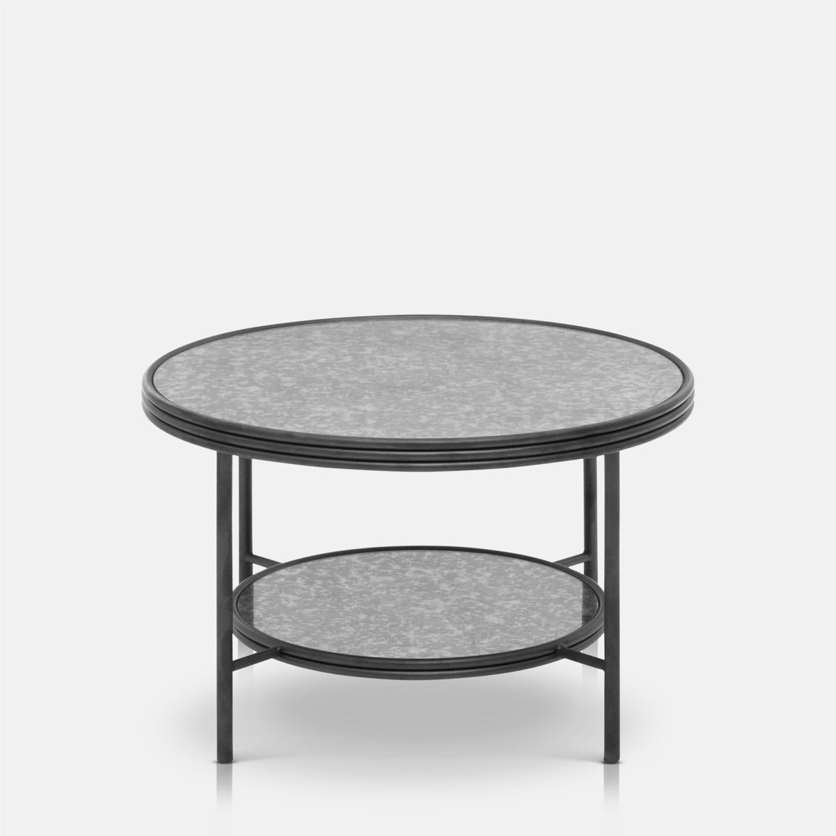 Abigail Ahern Leiden Metal Coffee Table with an antique mirrored glass top and slim metal frame, featuring a two-tier design for stylish storage in a contemporary living room.