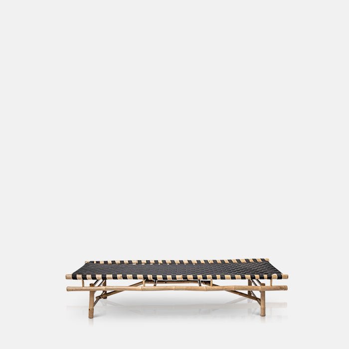 A cutout of the Levada Daybed. A bamboo outdoor daybed with black top pictured from the side.