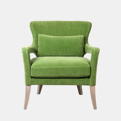 Cutout image of bright green club chair with wooden legs. This designer accent chair has classic shape with a soft, velvet fabric, and is very comfortable.