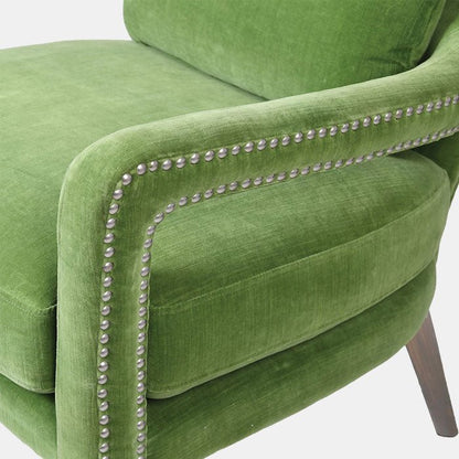 Detail photo of the arm of the Linton Studded Club Chair, a bright green, velvet accent chair from bestselling Interior designer Abigail Ahern.