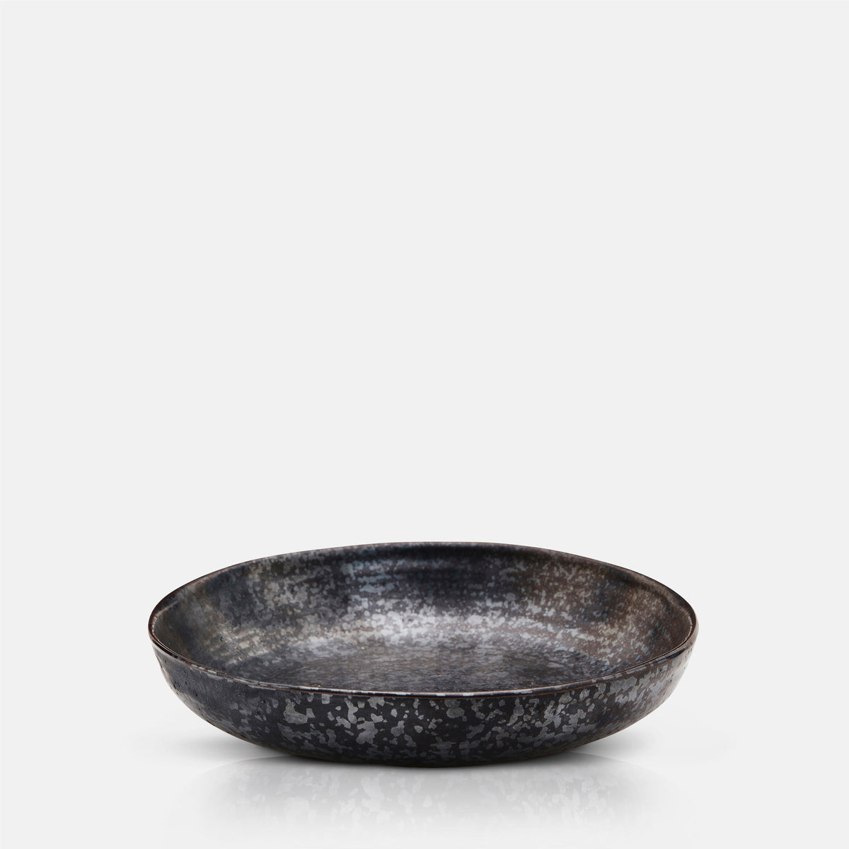A cutout of the Marple Stoneware Bowl Charcoal, a wide shallow stoneware bowl in an inky black colour.