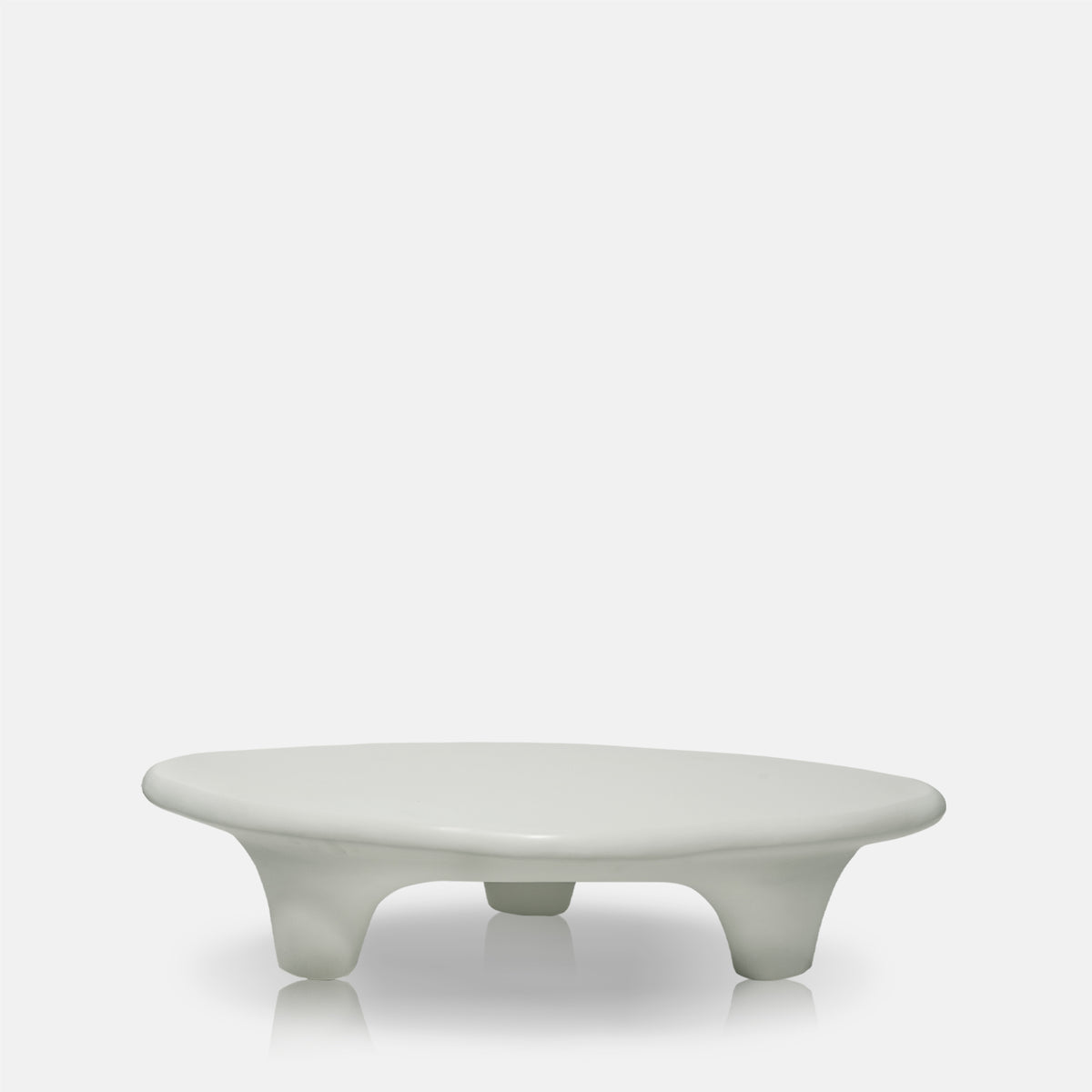 Cream stone effect coffee table with a sculptural round design, curved silhouette and textured organic finish. Medina Coffee Table by Abigail Ahern, featuring a contemporary shape and neutral tones that create an elegant centrepiece for modern living rooms and luxury interiors. A statement designer coffee table perfect for styling with decorative accessories, books and lighting, adding natural texture and timeless sophistication to your home decor.