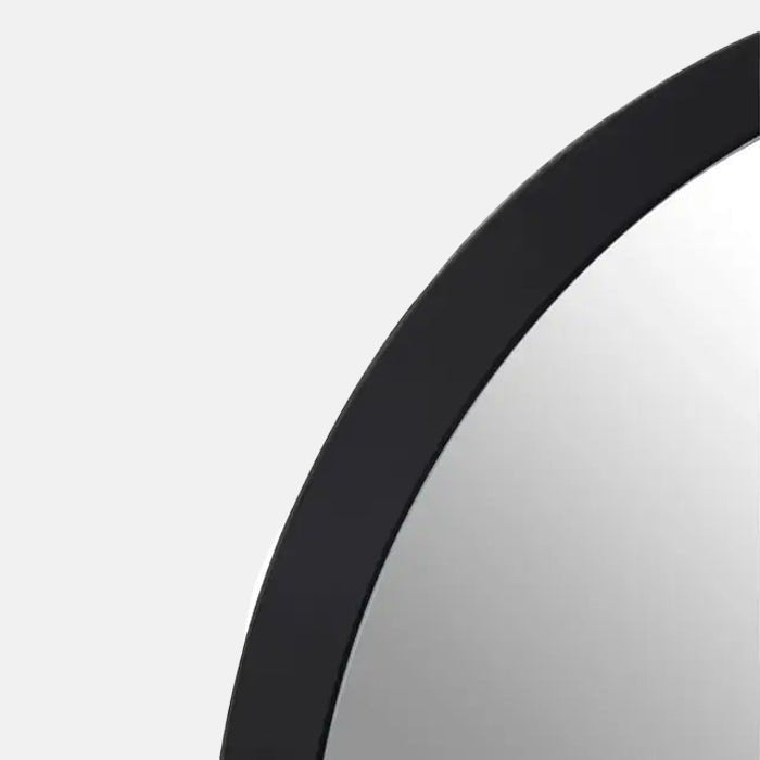 A closeup of the smooth black MDF frame on the Medium Della Mirror.