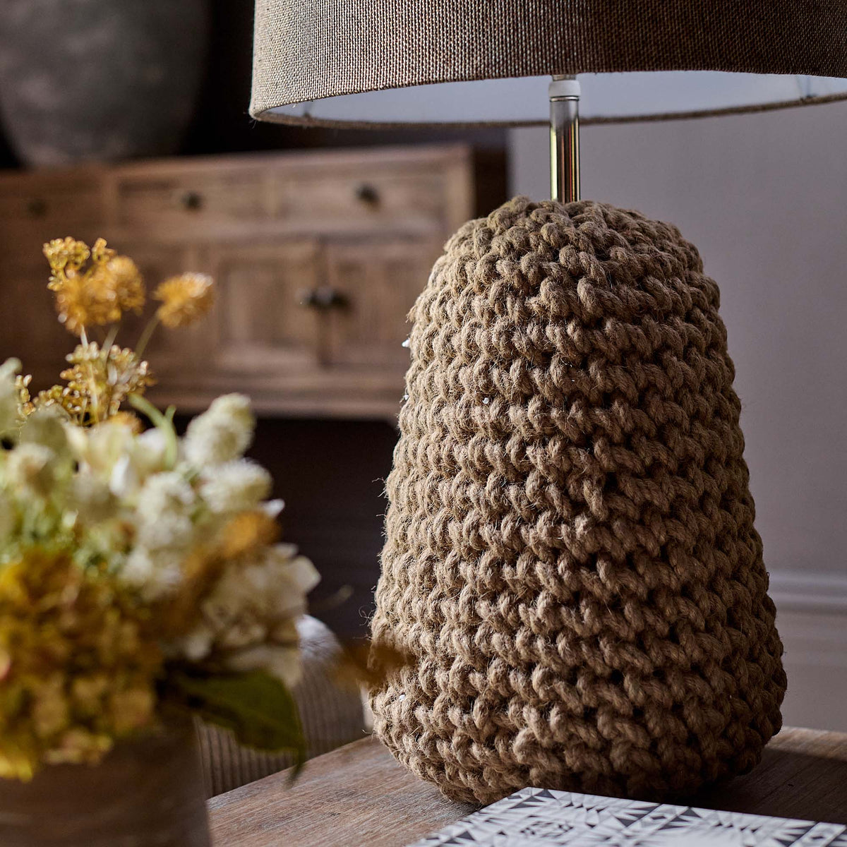 A closeup of the knotted jute detailing on the base of the Milton Table Lamp.