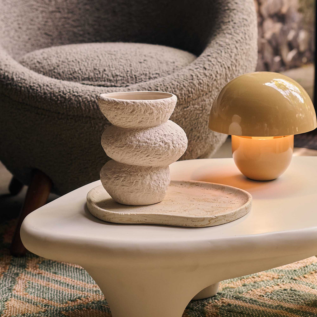 Low cream coffee table with rounded legs , organic shape , smooth finish, designer look, neutral interiors, warm toned eclectic living room styling. Abigail Ahern
