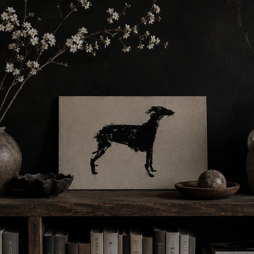 Murphy Dog Print displayed above a dark console table, featuring a black brushstroke dog silhouette with stacked books, textured vases and neutral accessories.