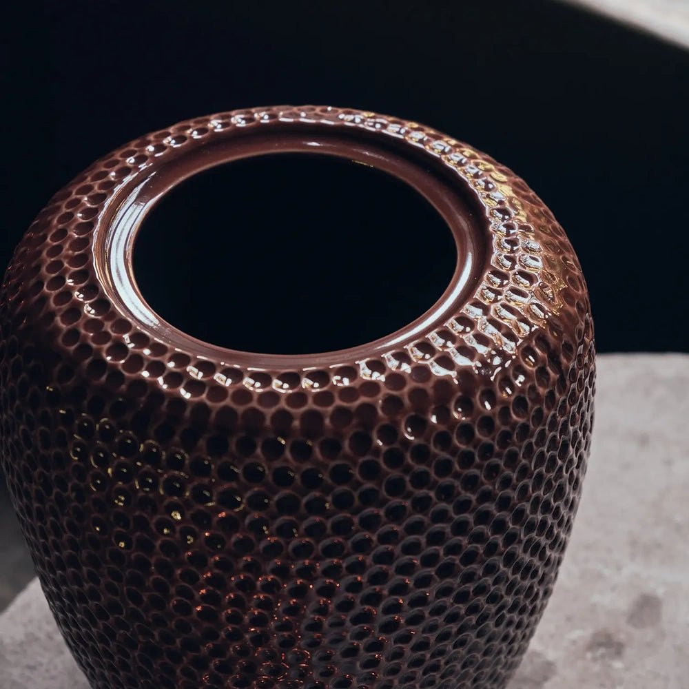 Nara Ceramic Jar shows its circular opening and glossy terracotta rim, with a deeply dimpled outer surface highlighted in a close-up view from above.
