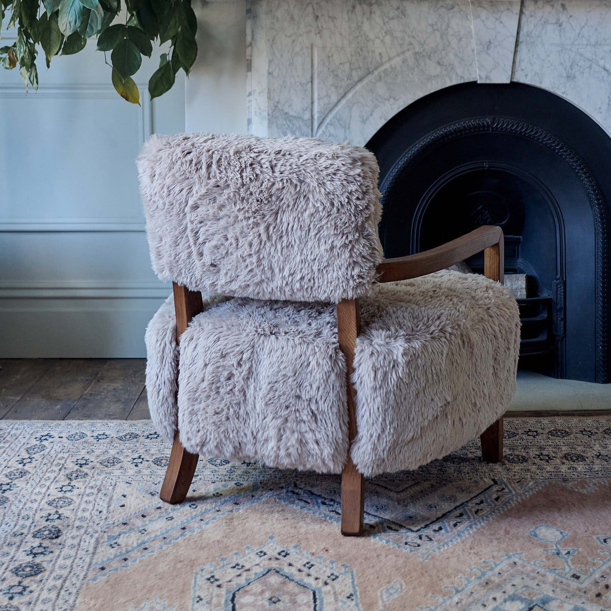 The Ottawa Faux Fur Armchair, a modern chair with a large square seat upholstered in soft beige faux fur with a wooden frame.