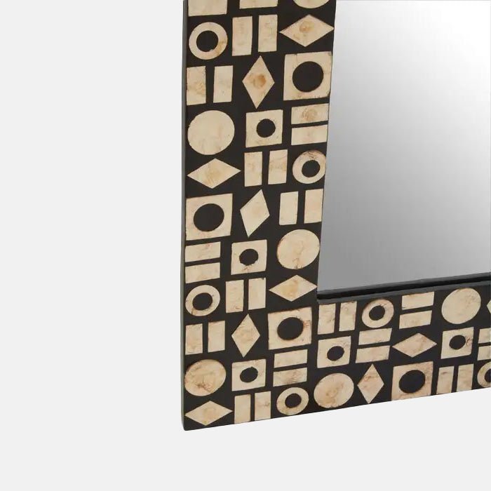 A closeup of the frame of the Palu Rectangular Mirror, showing the pearlescent effect and the pattern made of mixed shapes.