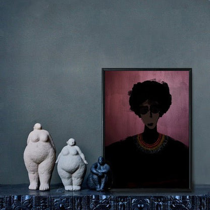 Female figure on a pink background in a thin frame leant against a wall next to three female sculptures
