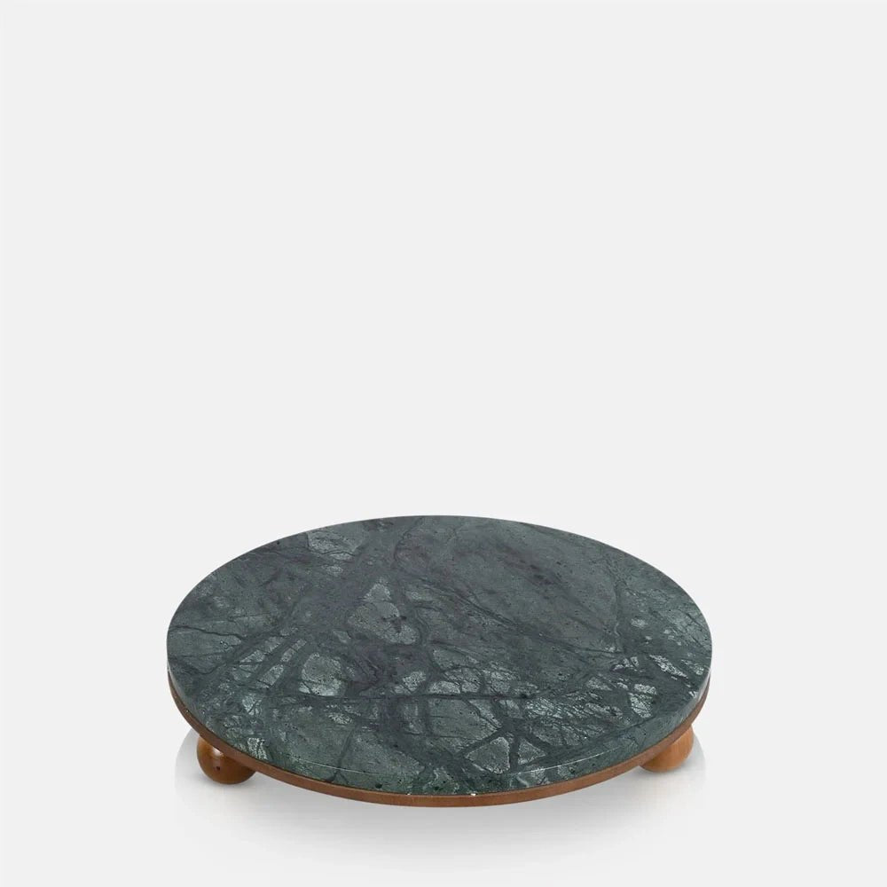 Remington decorative tray with a flat circular green marbled surface, slim warm wooden edge and rounded feet that raise it slightly above the surface beneath.