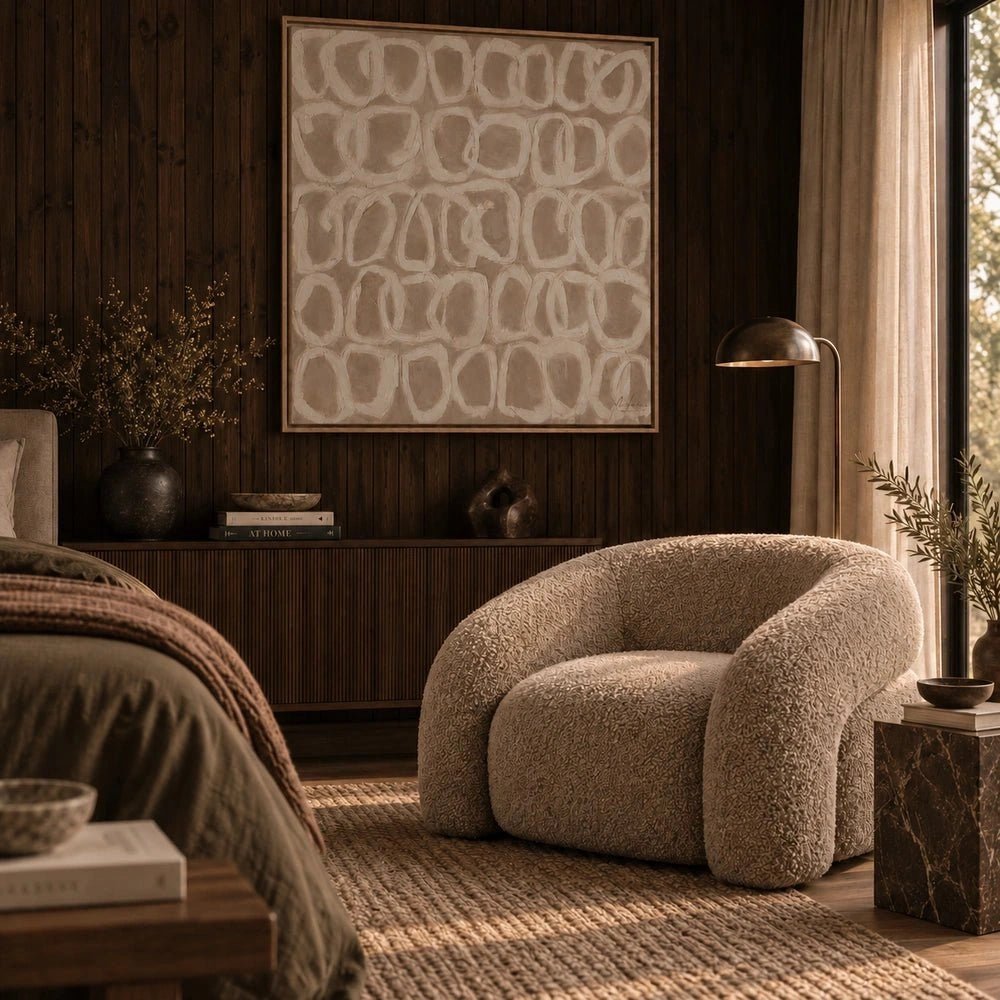 Ripple Canvas Art displayed above a dark sofa in a neutral living room, showing layered black and cream horizontal forms within a slim black frame.