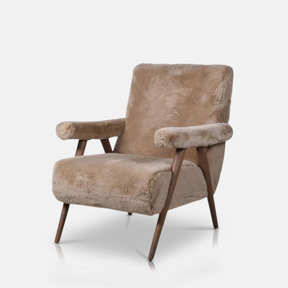 Cut out of the Beige faux sheepskin armchair with a soft textured upholstery, padded armrests and a timeless solid oak frame. Robbins Faux Sheepskin Armchair by Abigail Ahern, a luxury accent chair designed to bring warmth, comfort and natural elegance to modern living rooms, bedrooms and cosy reading corners. A statement piece of furniture perfect for creating a sophisticated, inviting and contemporary interior.