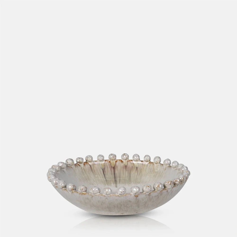 Rutledge bobble decorative bowl with a shallow rounded shape, glossy cream interior, weathered outer finish and small spherical details running around the gently raised rim.
