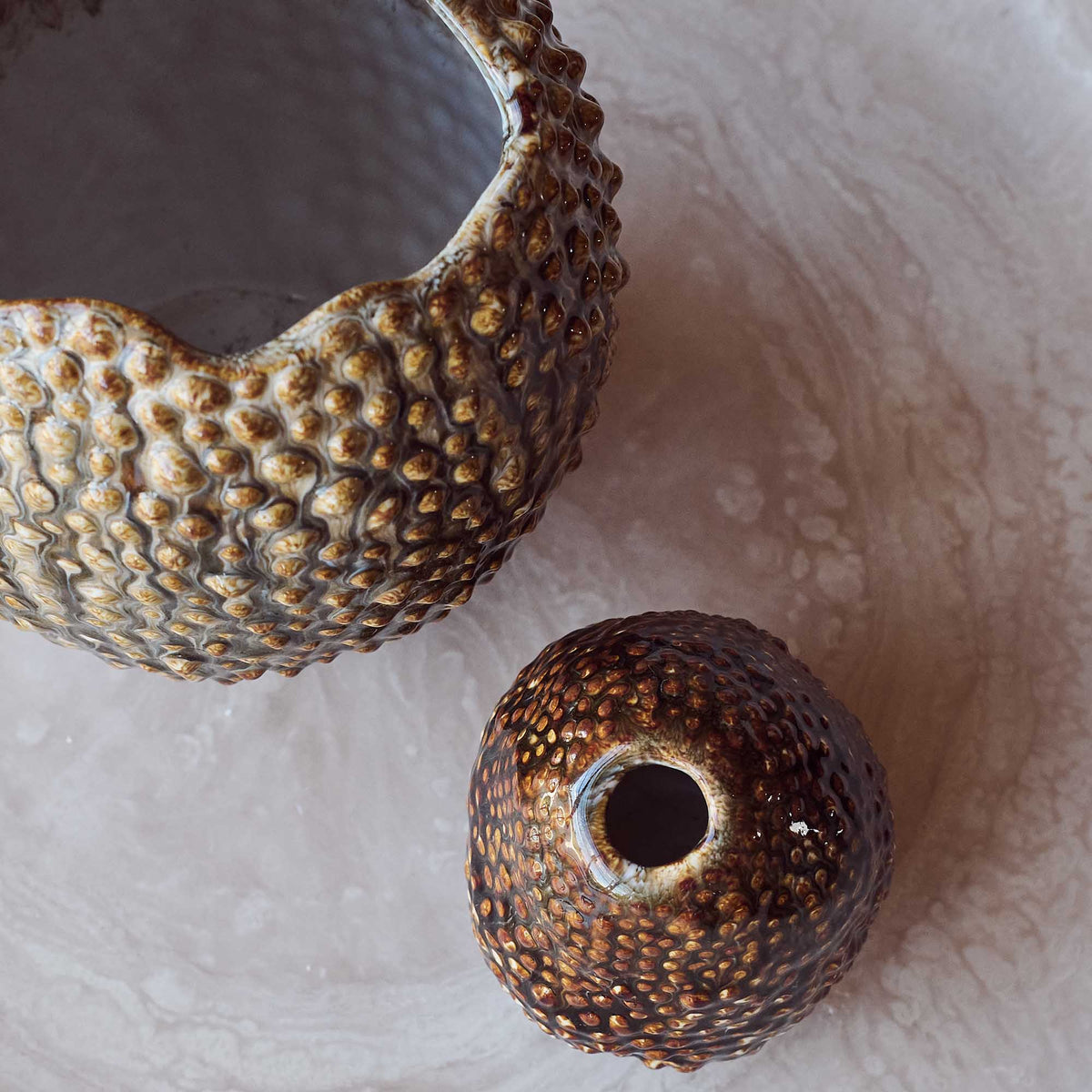 Textured ceramic vases on a textured surface