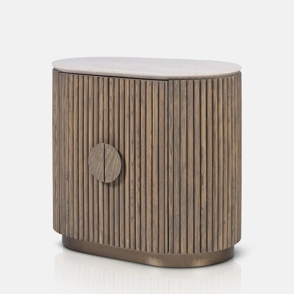 Sheridan wooden cabinet with vertically fluted curved doors, a round central handle, pale rounded top and recessed base, shown from a slight angle.