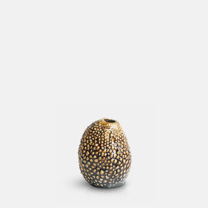 Cutout image on a white background of a small ceramic vase with a raised brown speckled texture.