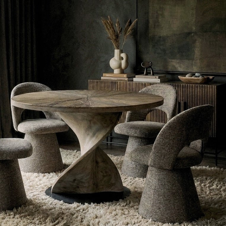 Abigail Ahern Spelthorne Twisted Wooden Dining Table in warm natural recycled elm with a round 118cm tabletop and sculptural twisted base, creating a statement centrepiece for the dining room.