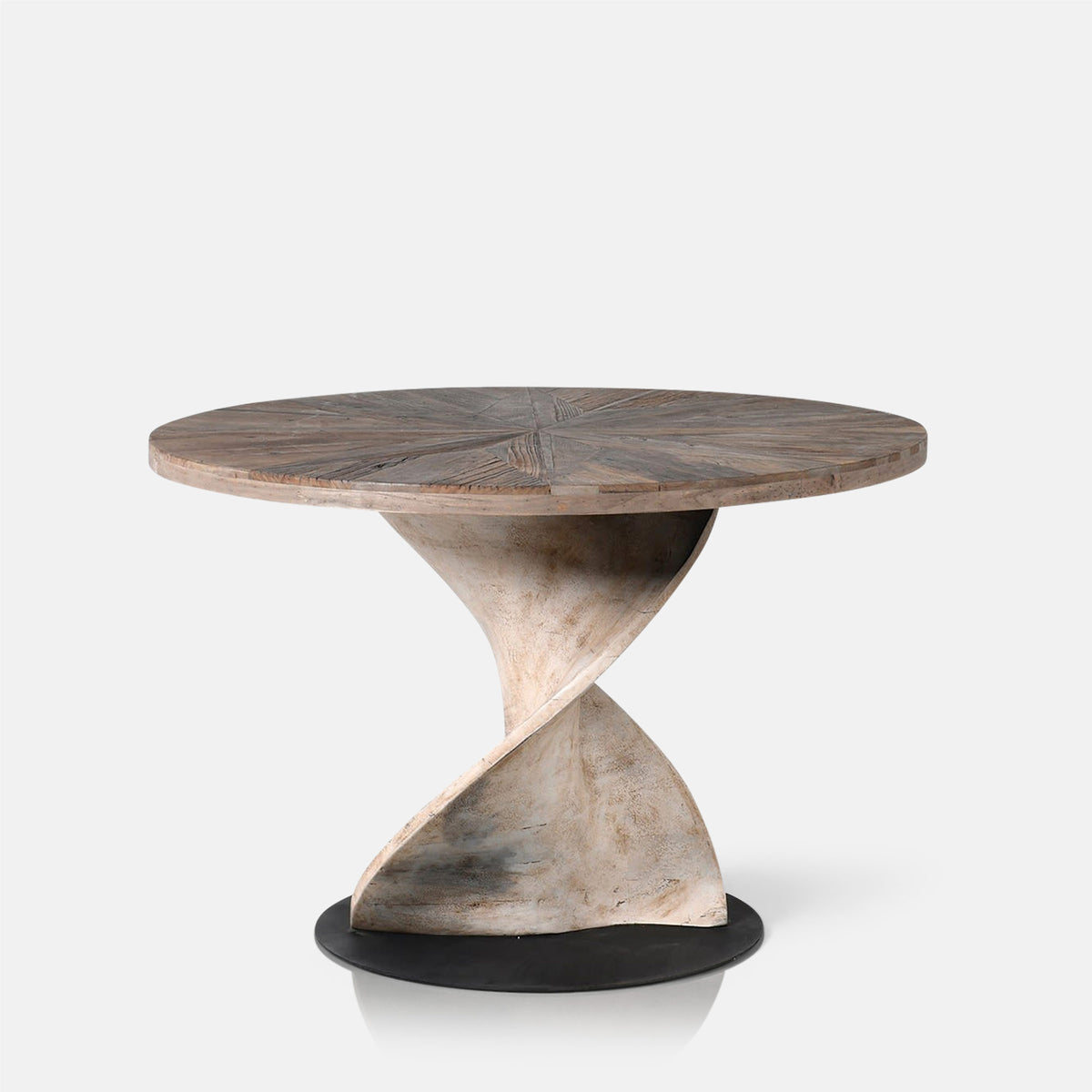 Abigail Ahern Spelthorne Round Wooden Dining Table featuring a characterful recycled elm finish and substantial twisted base, ideal for everyday dining and entertaining.