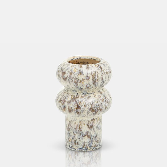 Cutout of the Tanda Stoneware Vase, a a ridged cylindrical vase with a speckled glaze in contrastic warm brown and cream tones