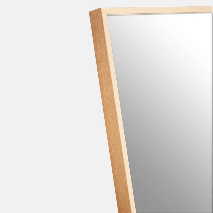 A closeup of the slim gold aluminium frame on the Teresa Gold Floor Mirror.