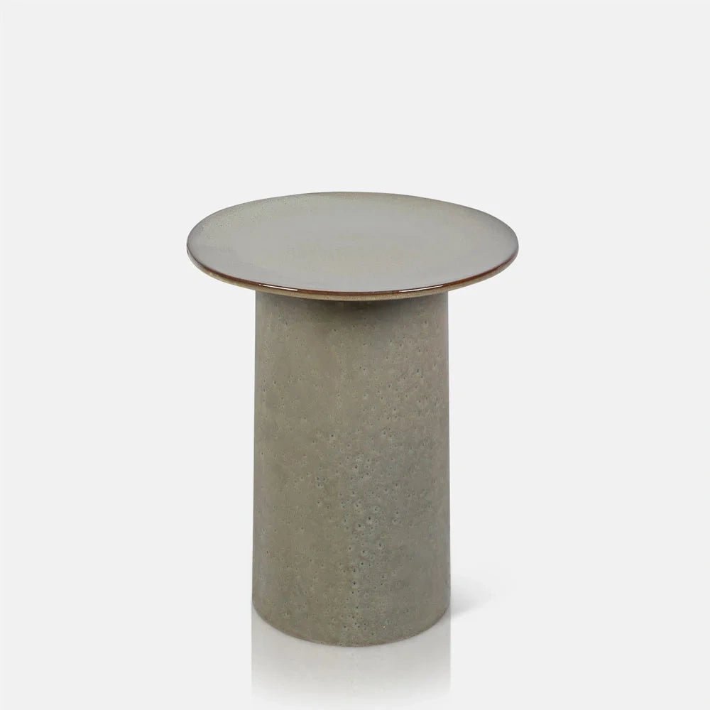 Thacker stoneware side table with a pale circular top, thin warm toned rim and a textured cylindrical base in softly mottled beige and grey.