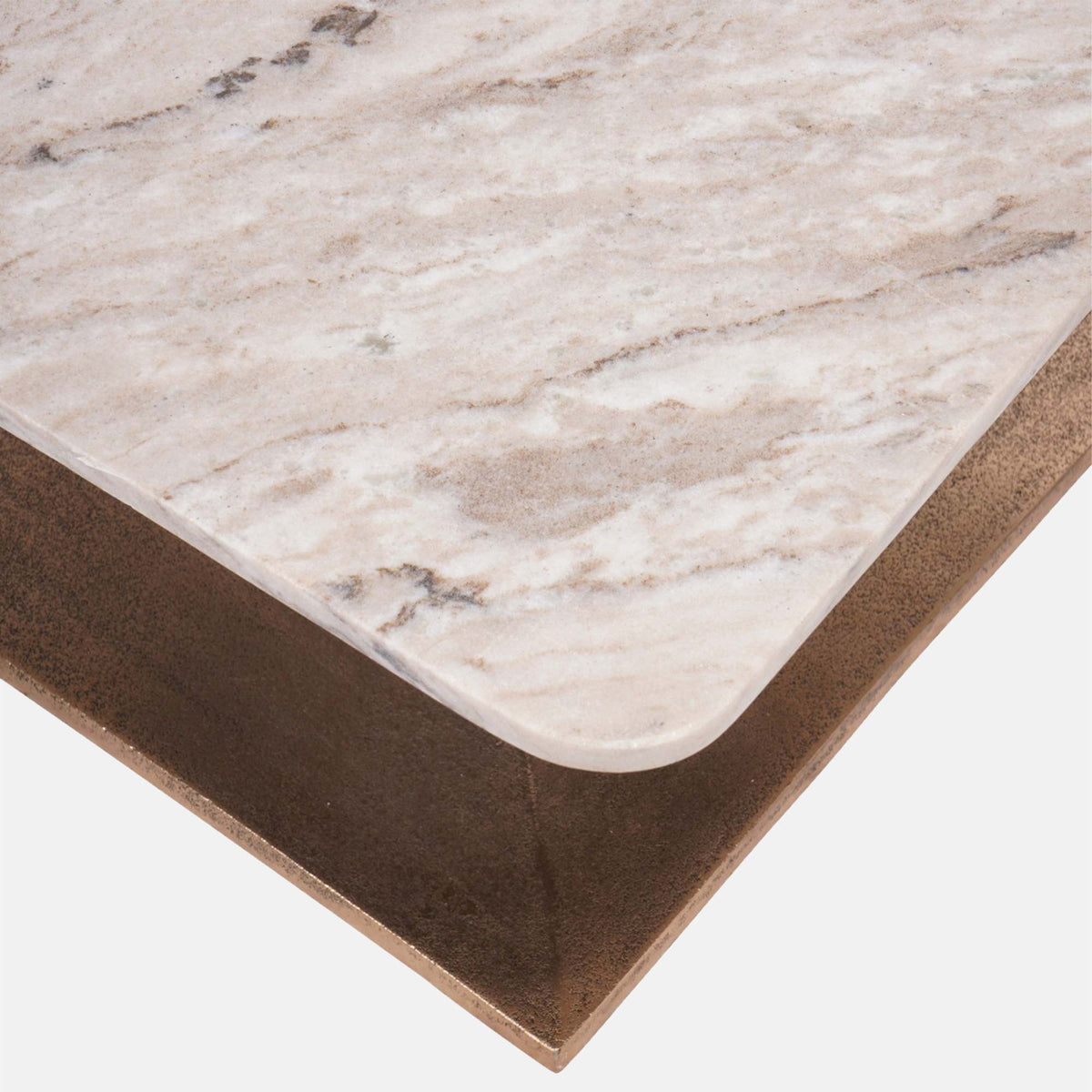 Abigail Ahern Waylon Marble Coffee Table shown from an angled view, highlighting its substantial sculptural form, natural surface and unique marble veining