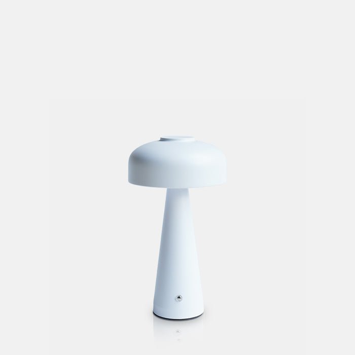 Cutout image on a white background of a rechargeable table lamp. This cordless lamp has a curved dome top and white finish.