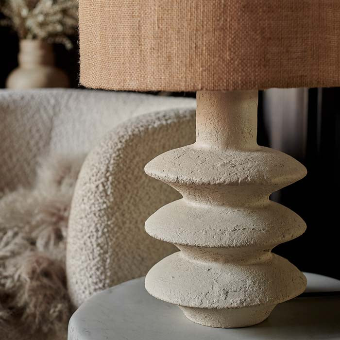 Tiered sculptural lamp base with rustic texture.