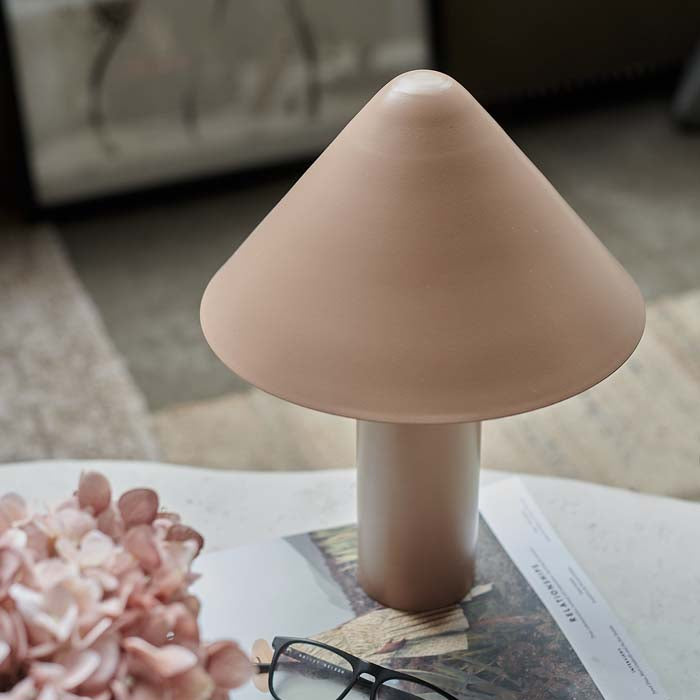 Conical shade on blush coloured table lamp.
