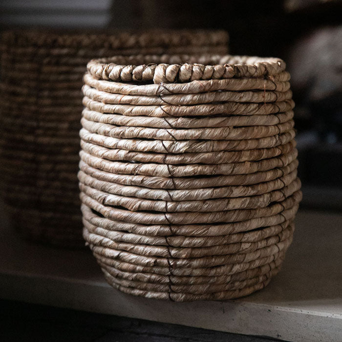 Round woven basket with black stitching
