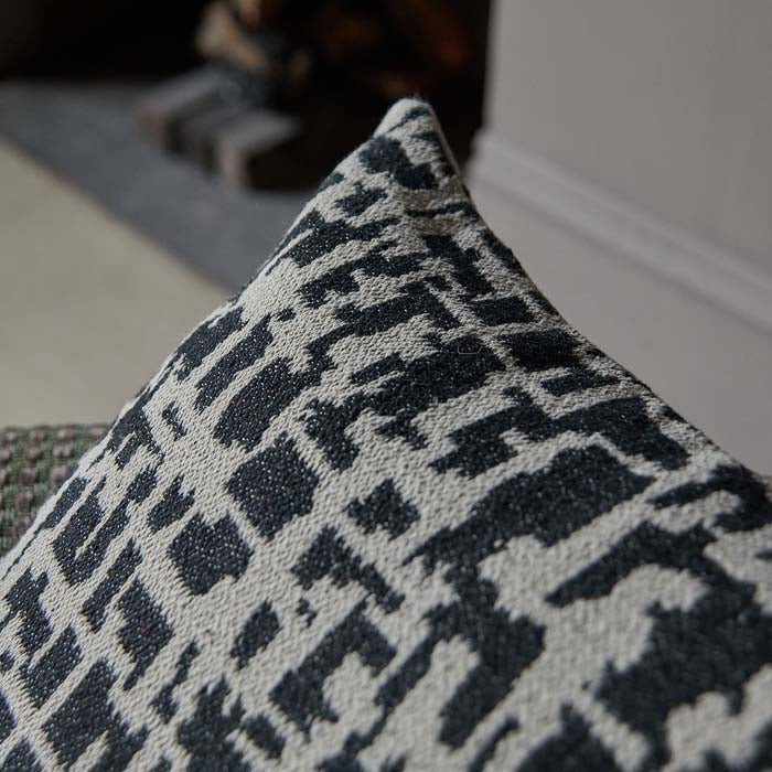 Woven textured monochrome abstract cushion.