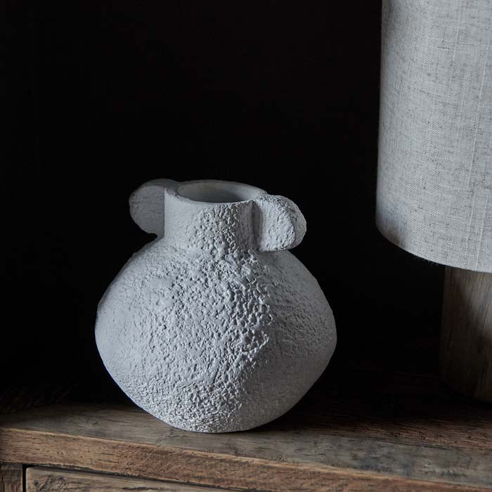 Round white ecomix vase with scalloped handles on neck.