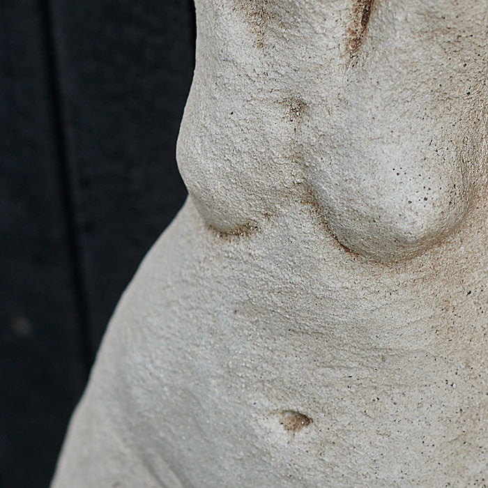 Rustic finish on a cement figurative sculpture.