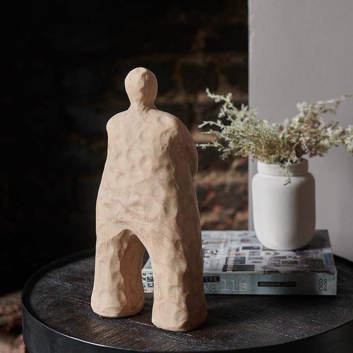 A rustic sandy brown abstract standing sculpture, crafted from polyresin.