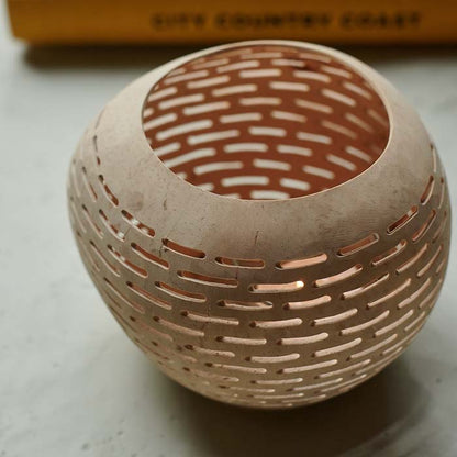 Round coconut tealight holder with cut-out horizontal line design.