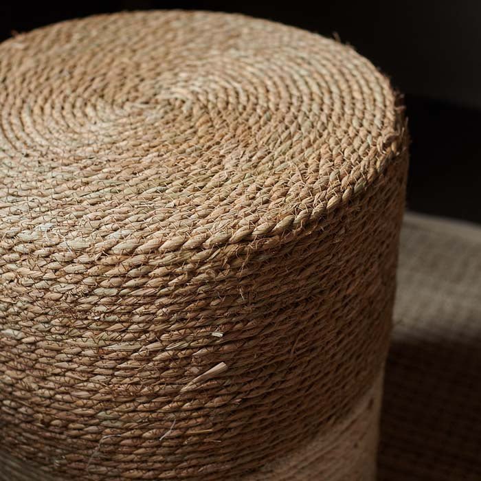 The Hadlow Woven Rope Stool, a cylindrical stool covered in rope in a two tone cream and natural colourway.