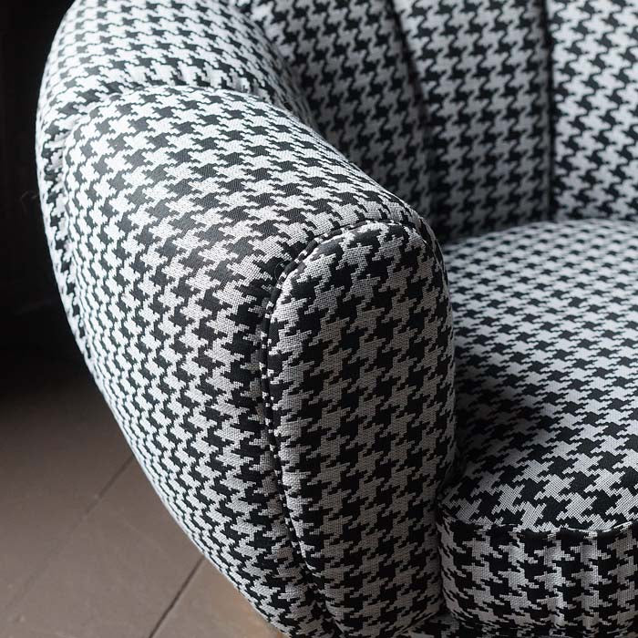 Black and white houndstooth fabric on armchair.