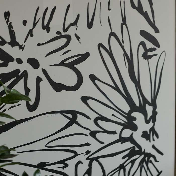 Black line drawing of daisies on a white background