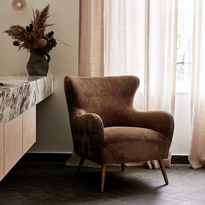 Leopard print velvet curved armchair.